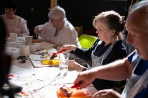 participants painting with a roller