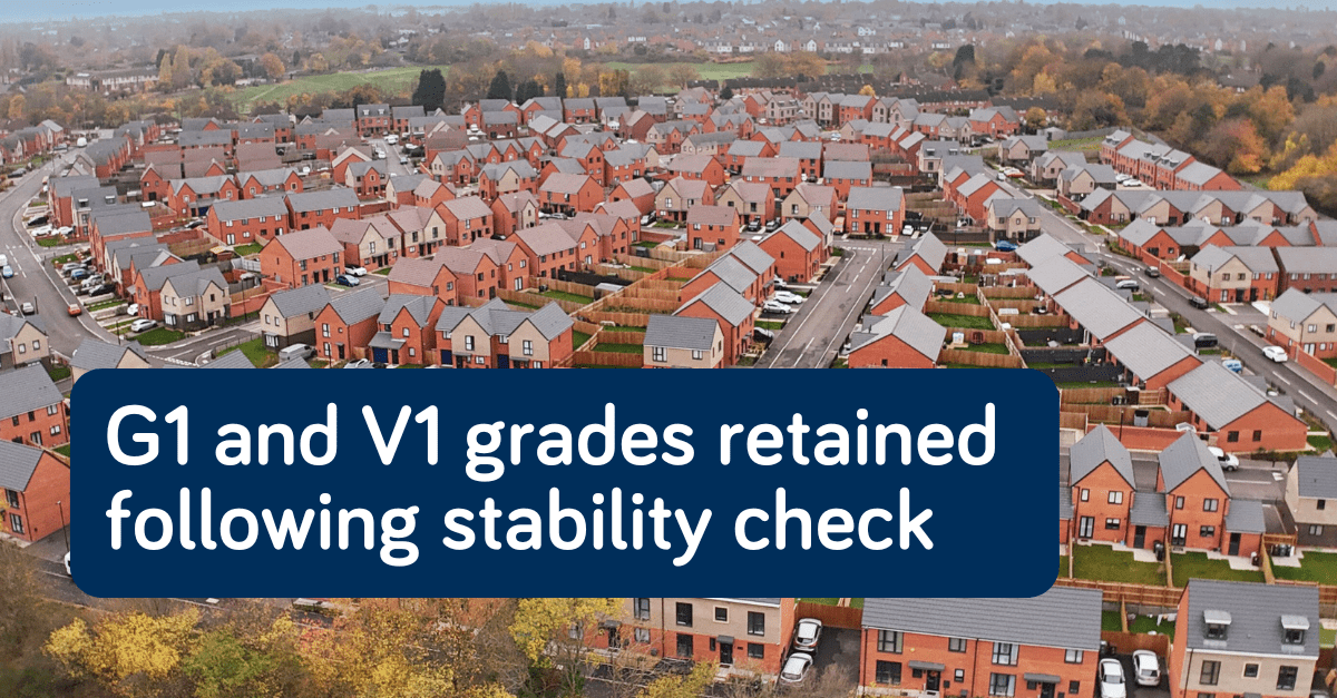 Aerial view of a new housing development with overlaid text: “G1 and V1 grades retained following stability check.”