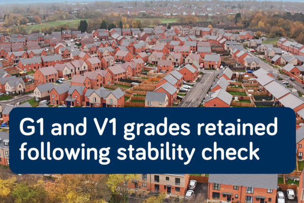 Aerial view of a new housing development with overlaid text: “G1 and V1 grades retained following stability check.”