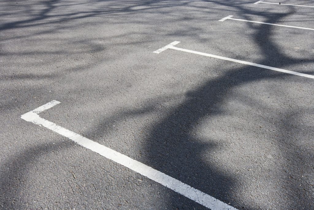 White painted lines marking a parking bay on tarmac