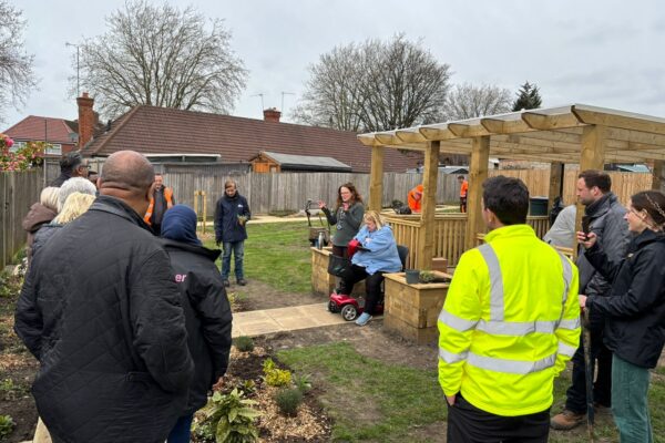 People standing in a community garden in Palfrey