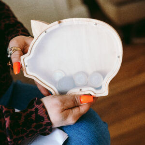 a clear piggy bank with coins inside