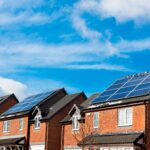 A row of houses with solar panels on the roof